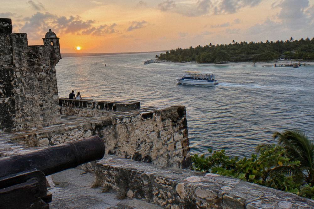 Oceanfront promenade in Santo Domingo at sunset with calm water and open sky