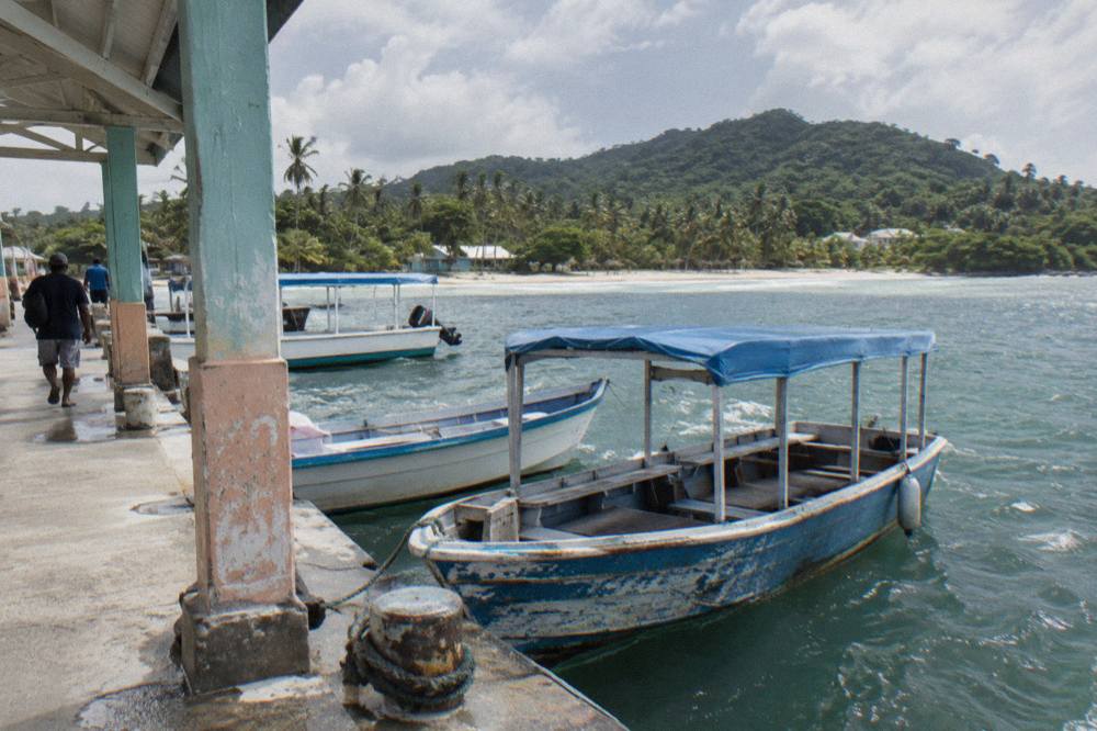Wooden boats moored at a dock on the Samana waterfront in morning light